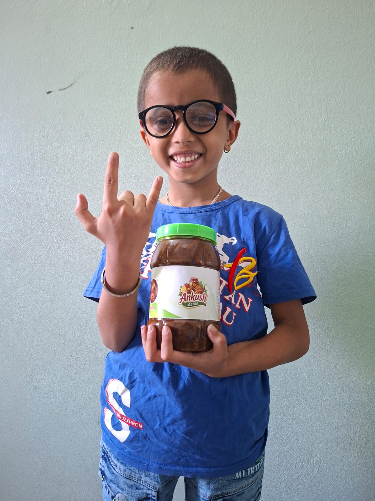 A family member of Ankush Achar holding a jar