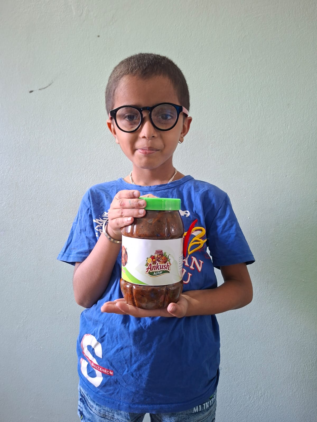 A young customer holding an Ankush Achar jar