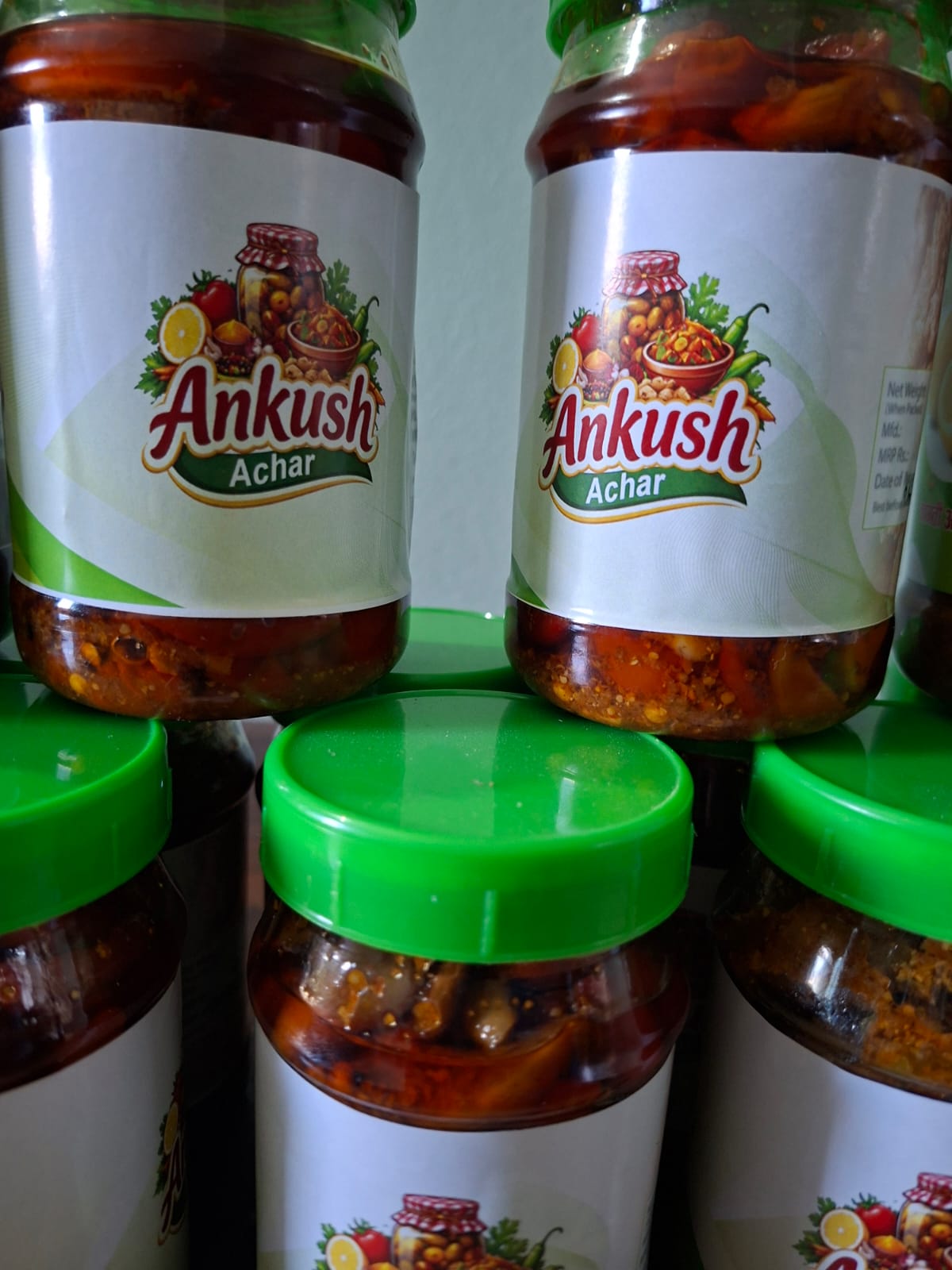 Ankush Achar jars close-up — green lids, branded labels
